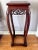 A beautifully carved Chinese rosewood pedestal plant stand, featuring elegant curved legs and intricate openwork carving...