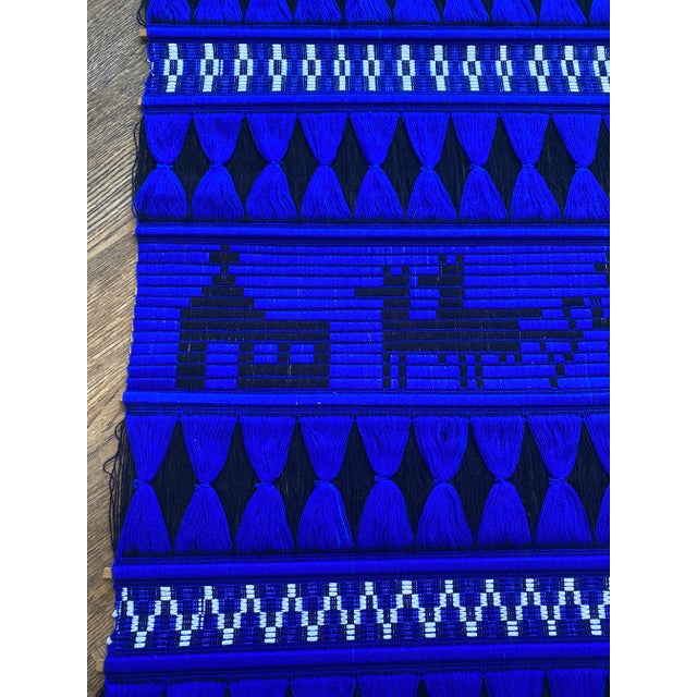 Vintage large Ecuadorian wall hanging. Woven with vibrant blue and black thread. Pattern is Aztec-like with animals. Looks...