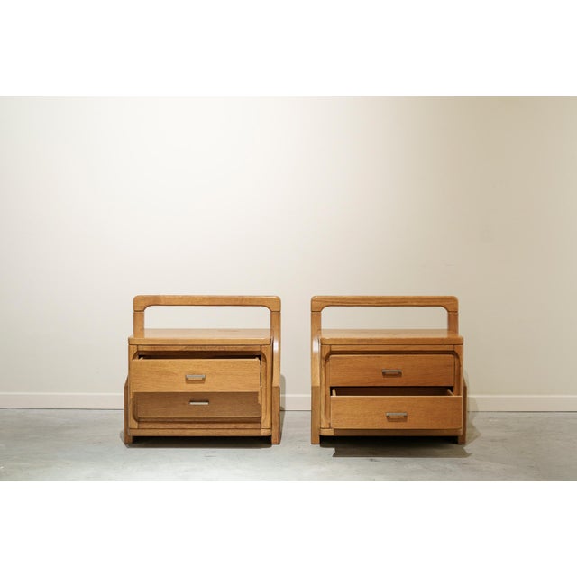 Pair of bedside tables with two drawers each, made of oak with silver-plated metal handles. Rectangular structure with a...