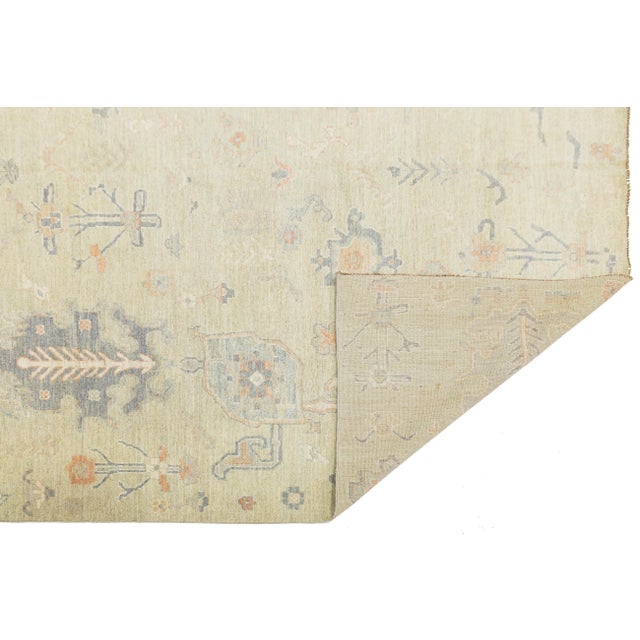 This stunning Modern Oushak Style rug perfectly blends traditional Anatolian motifs with a contemporary, high-end color...