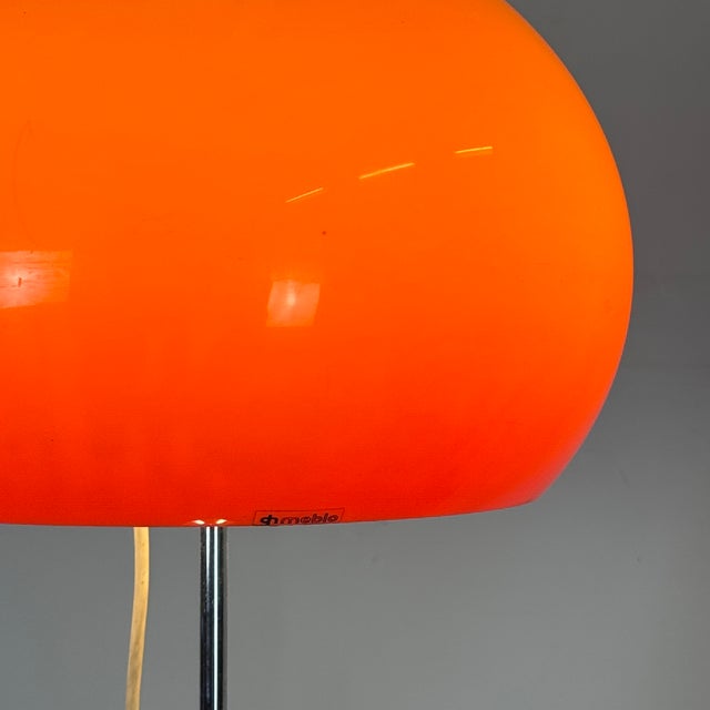 A striking mid-century italian floor lamp designed by harvey guzzini for meblo in the 1960s. Featuring a vibrant orange...