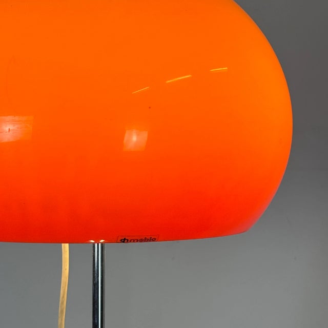 A striking mid-century italian floor lamp designed by guzzini for meblo in the 1960s. Featuring a vibrant orange shade and...