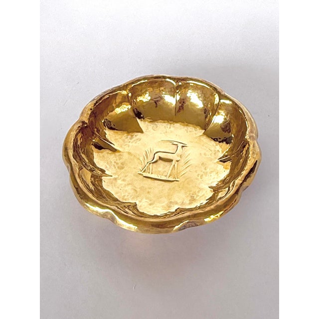 A hand-worked brass bowl, signed and dated Dresden, 1925. It has a hand-hammered scalloped edge with a Deco-styled...