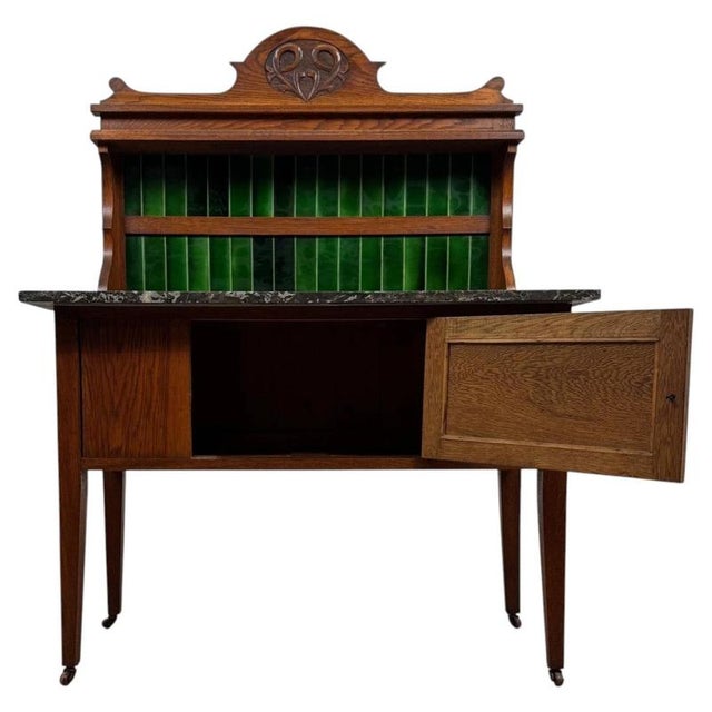 A handsome early 20th-century English Arts and Crafts washstand, finely crafted from oak and distinguished by its striking...