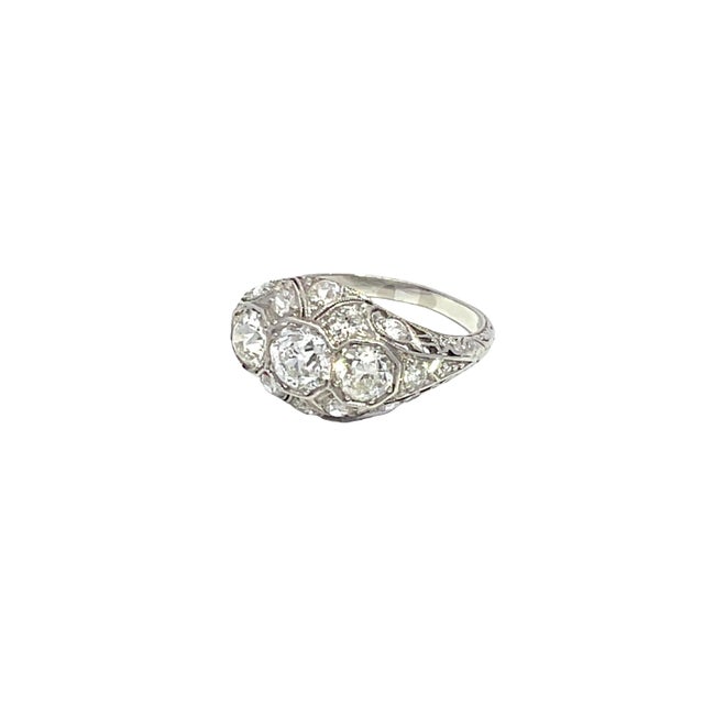Discover the timeless elegance of this exquisite diamond ring, crafted in luxurious platinum. Featuring three stunning...