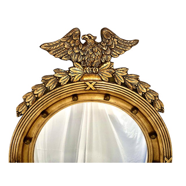 On offer is an elegant gilt wood "bullseye" convex mirror, which expresses a classic American Federal period aesthetic...