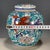 A striking Chinese porcelain covered jar decorated in vibrant Wucai (five-color) enamels. The white ground is vividly...