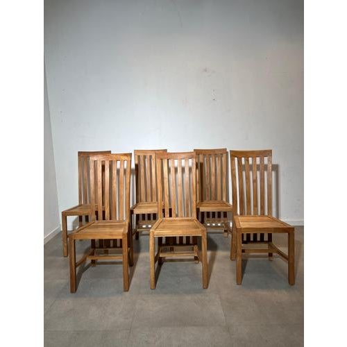 Beautiful set of six solid teak dining chairs featuring a timeless high slatted back design. The elegant vertical lines...