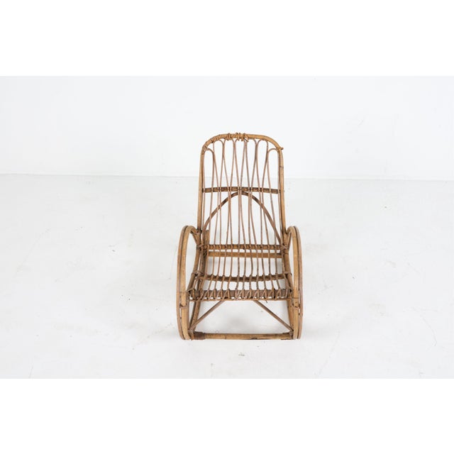 Pretty stunning little rocking chair made of bamboo and rattan. In good condition with some loose rattan pieces. No label...