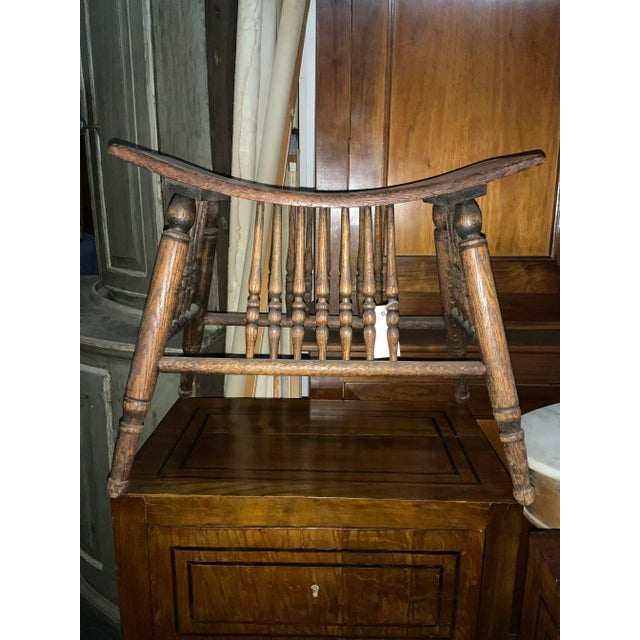 A small wood-carved curule stool from England. This English wood stool is from the early 20th century. This sweet sized...