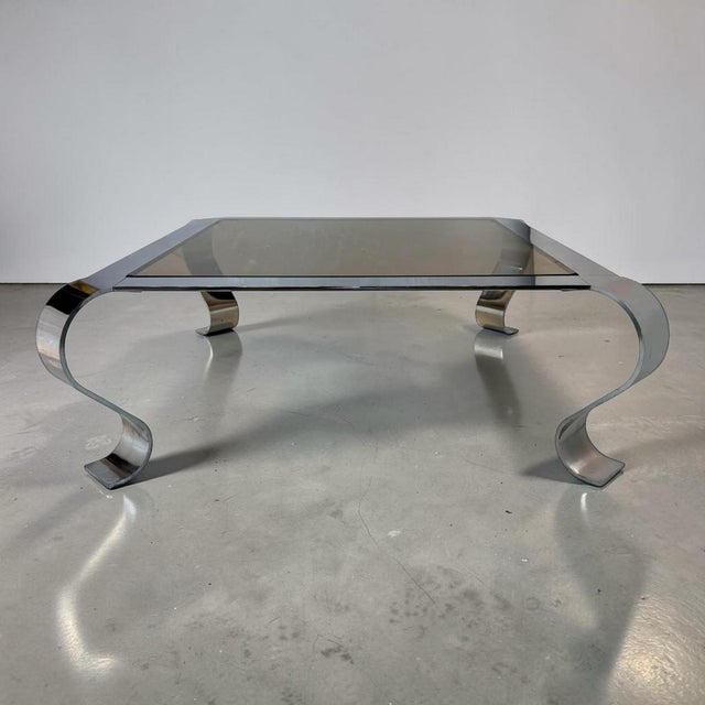 Incredible French mid-century chrome coffee table with a square insert smoked glass top that lays in the center of the...