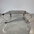 Incredible French mid-century chrome coffee table with a square insert smoked glass top that lays in the center of the...