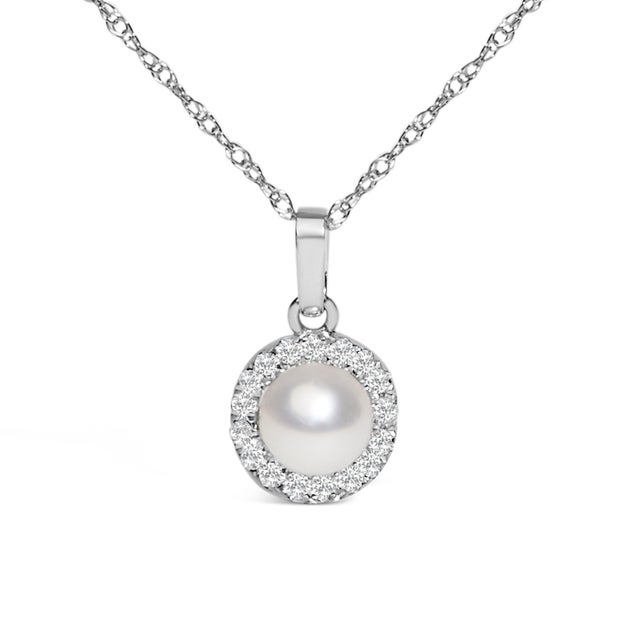 Emanating timeless elegance, this 10K white gold pendant necklace captures the essence of classic sophistication. At its...