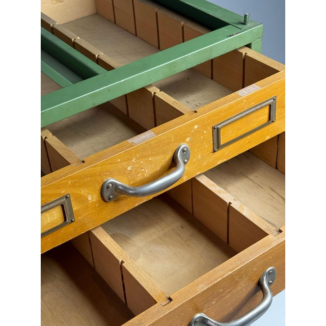This characterful tool or apothecary cabinet originates from the former GDR (East Germany) and brings authentic retro...