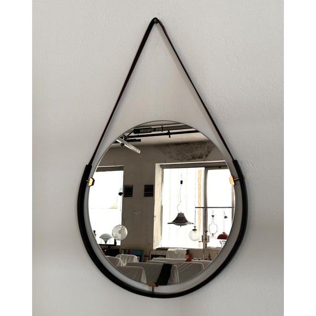 Italian Floating Wall Mirror with Leather Strap and Brass Details, 1960s Gorgeous floating wall mirror from the Italian...