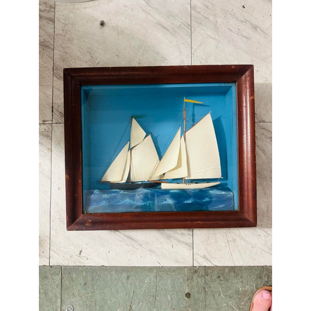 This charming vintage nautical shadowbox features a handcrafted three-dimensional sailing scene depicting two schooners...