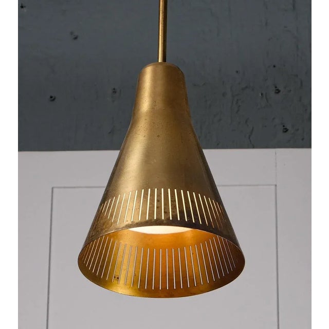 Produced by ASEA,, Sweden, 1950s. Rewired. Height is adjustable. Perforated brass. This piece is attributed to the...