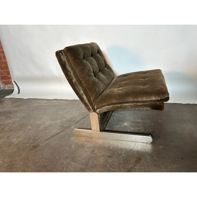 Italian mid-century lounge chair with a low, relaxed profile and deeply tufted seat and backrest supported by a minimalist...