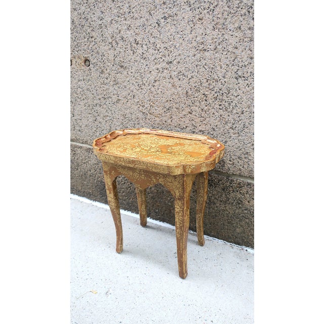 An Italian gold giltwood side, accent, drinks table with apron front and scallop-like design, in the Rococo design style,...