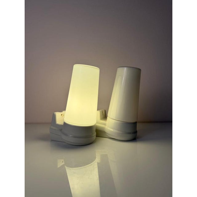 A Scandinavian design duo with character: This set of two wall lamps, model 6080, was designed by Swedish designer Sigvard...