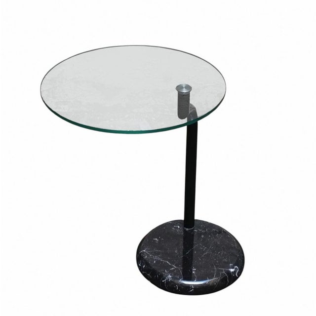 Round coffee table, 1980s, with glass top and black marble base. The distinctive feature of this table is its unusual...