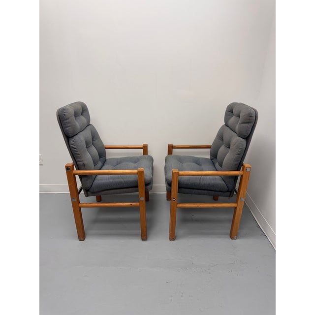 A stylish pair of vintage Danish Modern high-back lounge chairs dating to the 1970s, featuring striking, elongated...