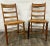This is a stunning pair of vintage Colonial style Ladderback dining chairs with caned seats. They feature beautifully...