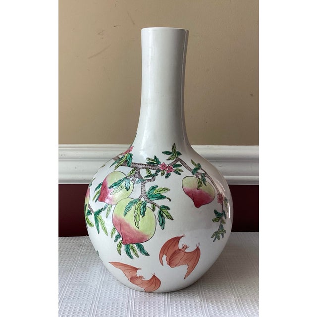 Celebrate the artistry and auspicious symbolism of traditional Chinese porcelain with this elegant Famille-Rose vase,...