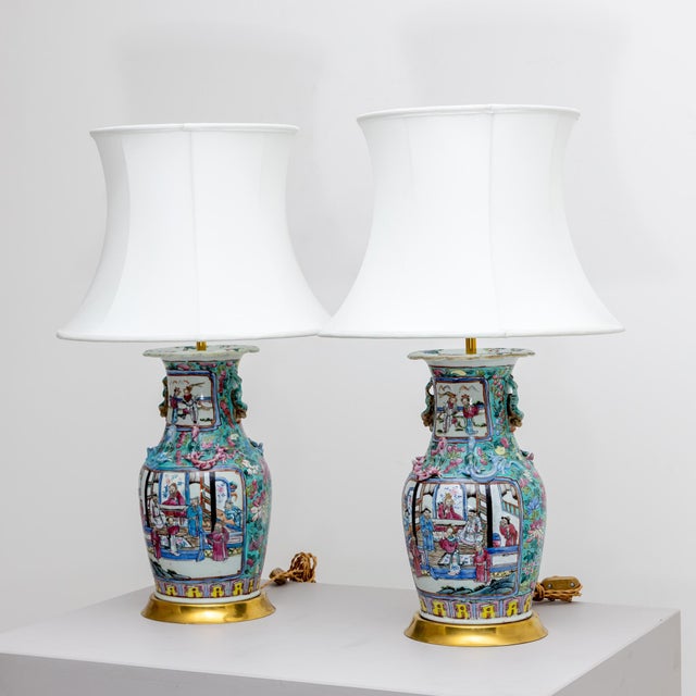 Pair of table lamps with polychrome painted porcelain vases as lamp bases and white fabric shades. European Plug (up to...