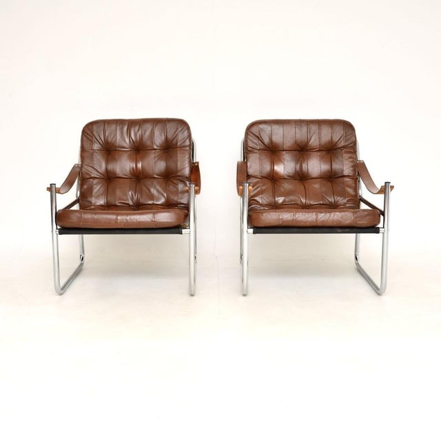 A stylish and comfortable pair of Danish vintage leather and chrome armchairs by Karin Mobring. They were designed for...
