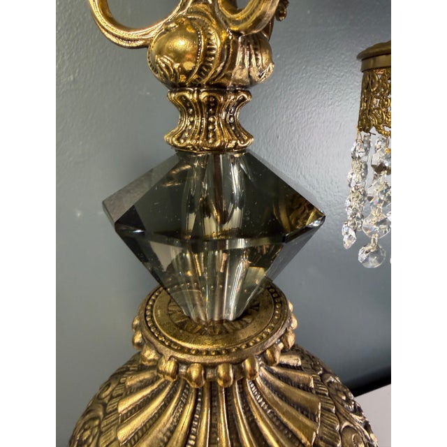 An elaborate vintage Loevsky & Loevsky (L&L WMC) table lamp combining ornate gold-tone metalwork with sparkling crystal...