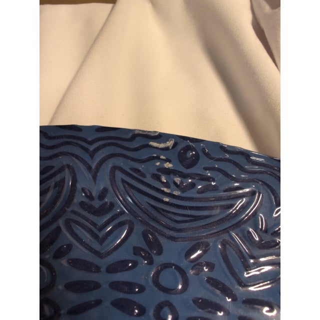 Decorative ceramic plate featuring an intricate blue pattern. • Eye-catching design with detailed patterns • Rich blue...