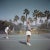 Tennis in san diego (1956) - limited estate stamped (photo by slim aarons) a man and a woman playing tennis on a court...
