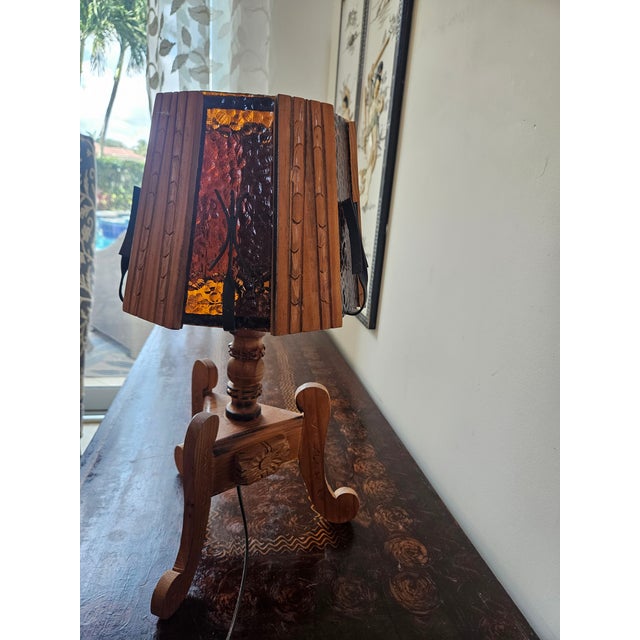 This recently rewired arts and crafts lamp includes hand carved decoration with wrought iron and glass panels. It could be...