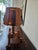 This recently rewired arts and crafts lamp includes hand carved decoration with wrought iron and glass panels. It could be...