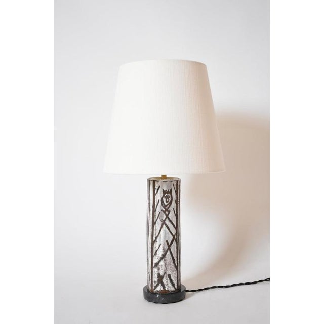 Glazed ceramic cylinder lamp with an incised pattern, 1950s. A ceramic glazed cylinder lamp with an incised black...