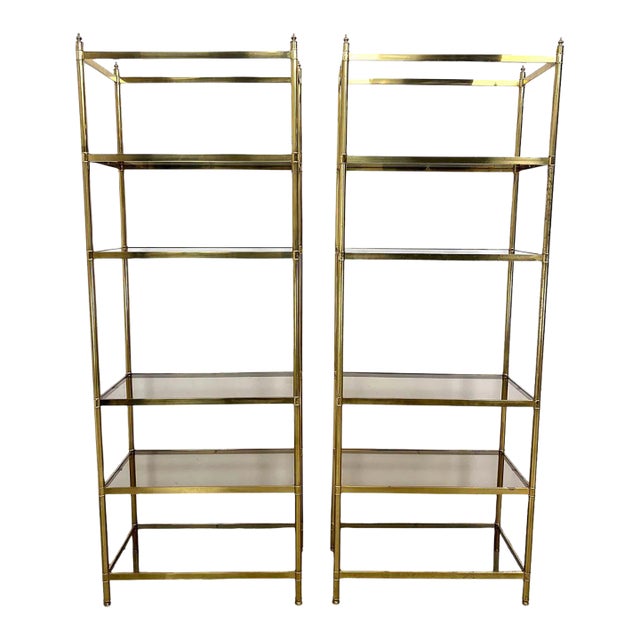 Pair of Billy Baldwin Style Brass Etageres With Smoked Glass Shelves For Sale