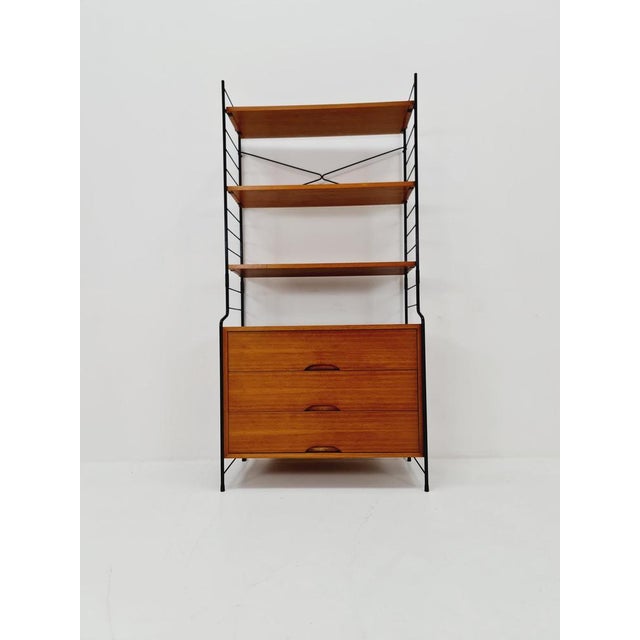 Free standing String shelf system, bookcase with cabinet teak by WHB Germany, 1950s The bookshelf system is in great...