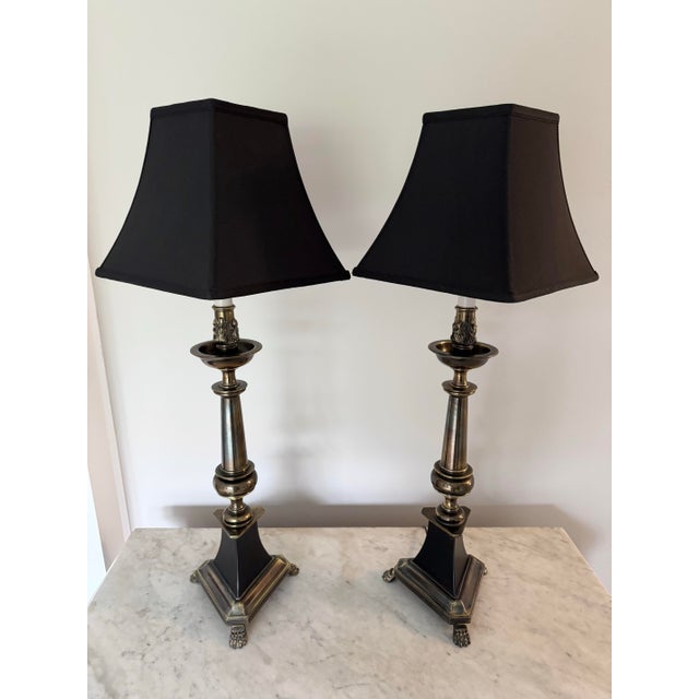 A fabulous pair of aged bronze and black enamel oversized table lamps by Stiffel, circa mid 20th c. Each lamp features...