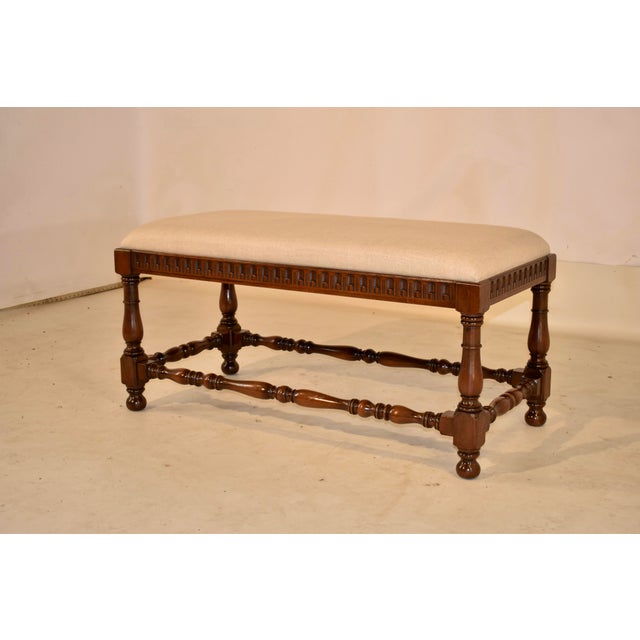 Circa 1900 English period Edwardian oak bench. The top has been newly upholstered in linen, and is supported on an oak...