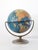 This is a Cram's Terrestrial world globe circa 1961. The 16 inch desk globe features a full brass meridian and metal base....