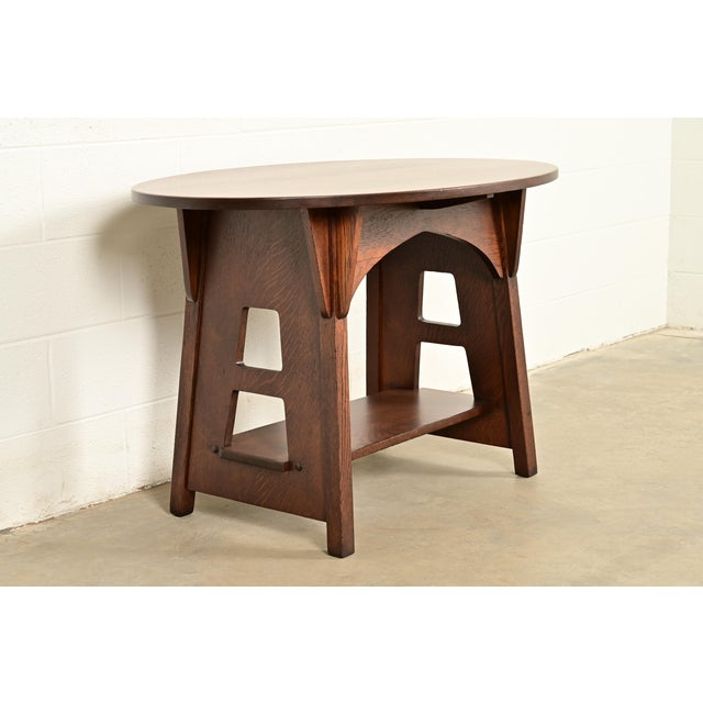 An outstanding Mission or Arts & Crafts period quarter sawn oak oval cutout center table or library Table By Charles P....