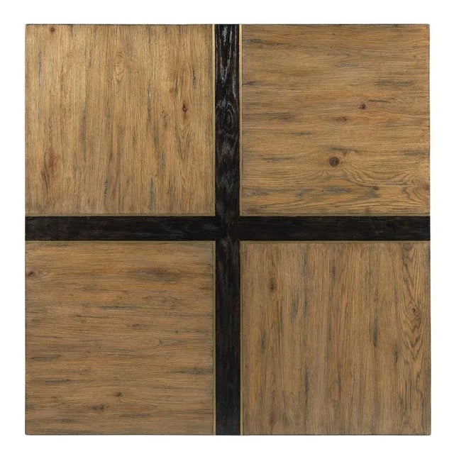 A handsome low table with a square top accented with darkened intersecting bands finished in worn black with a brass inlay...