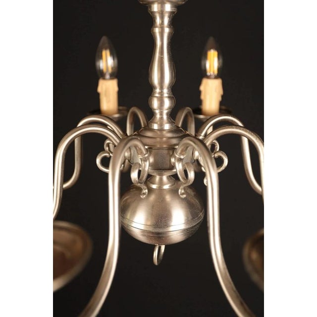 Interesting dutch-style chandelier made of white polished brass. The eight-arm design is also suitable for a larger room...