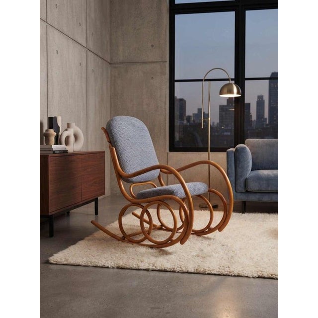 An elegant Mid-Century Modern bentwood rocking chair manufactured in the 1960s by the renowned Czechoslovak company TON...