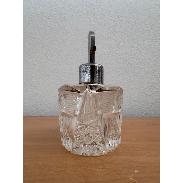 Elegant and luminous, this antique Bohemian perfume bottle dates to the 1920s and exemplifies the refined craftsmanship of...