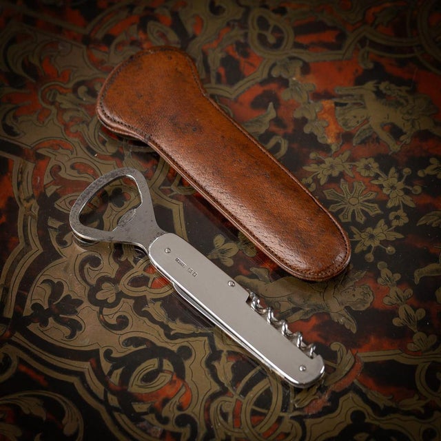 A superb 20th century english solid silver "barmans friend" combination tool consisting of a bottle opener, corkscrew and...