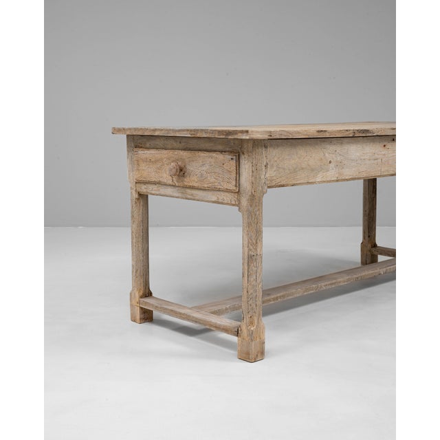 This 20th-century French oak trestle dining table showcases rustic simplicity and timeless craftsmanship. Built from solid...