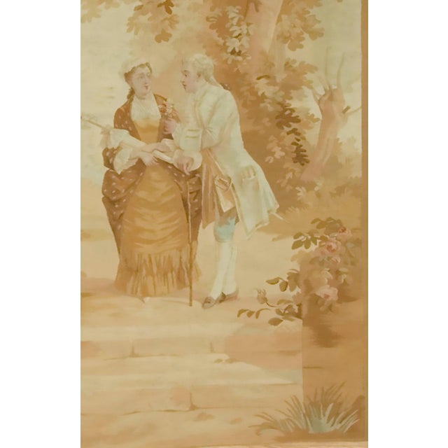 A fine wool and silk tapestry showing a courting couple in a woodland setting. Finely woven in Autumn colors this style of...