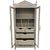 A tall painted display cabinet in a soft gray finish with glass-paneled double doors and two lower drawers.